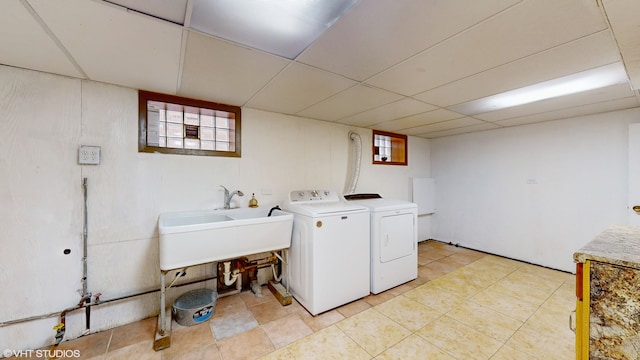 washroom featuring washing machine and clothes dryer and a wealth of natural light