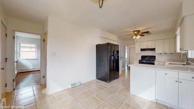 kitchen featuring ceiling fan, white cabinets, sink, and black appliances