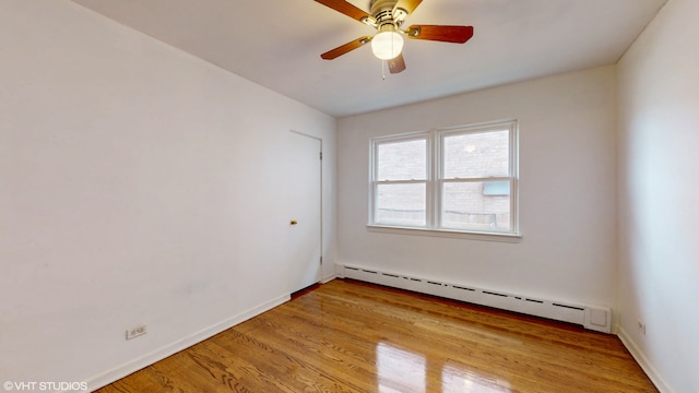 unfurnished room featuring ceiling fan, a baseboard radiator, and light wood-type flooring