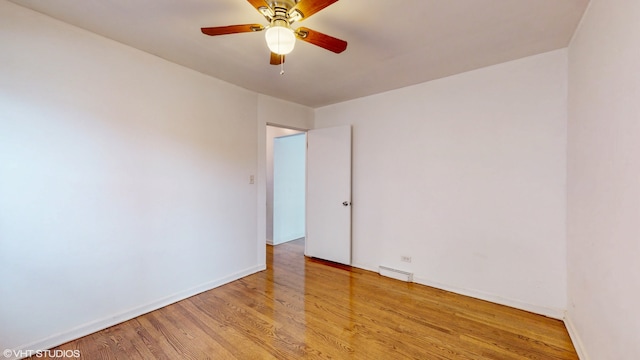 empty room featuring light hardwood / wood-style flooring, a baseboard heating unit, and ceiling fan