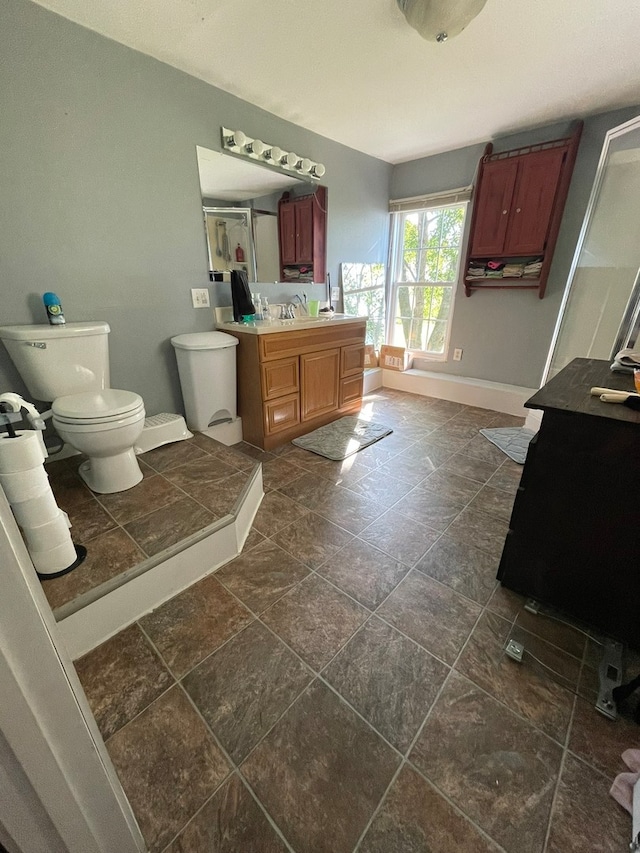 bathroom featuring vanity, toilet, and tile patterned floors