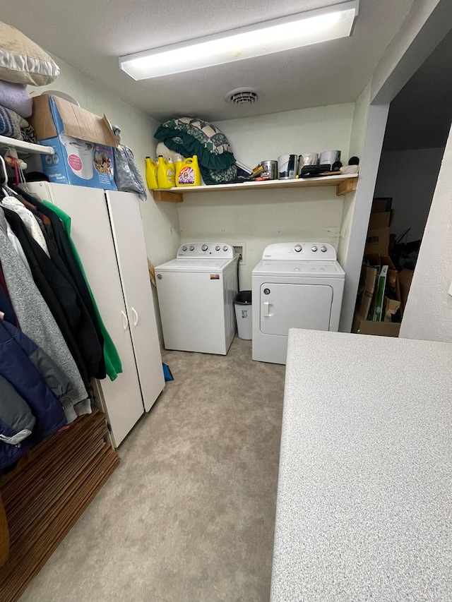 washroom featuring separate washer and dryer and light carpet