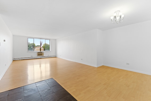 unfurnished room featuring light hardwood / wood-style flooring, a baseboard heating unit, and a chandelier