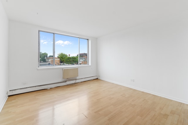 empty room featuring light hardwood / wood-style floors and baseboard heating