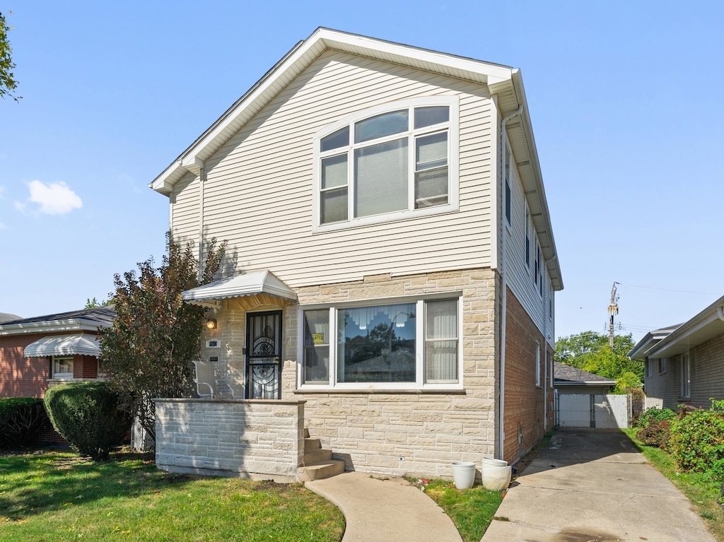 view of front of home with a garage and a front lawn