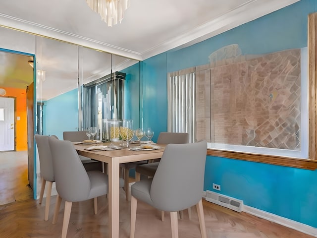 dining space featuring ornamental molding and light parquet flooring