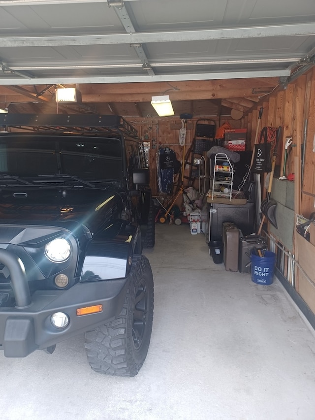 garage featuring wooden walls