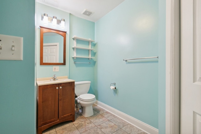 bathroom with tile patterned flooring, vanity, and toilet