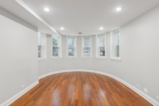 unfurnished room with hardwood / wood-style flooring