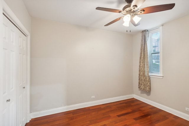 unfurnished bedroom with multiple windows, dark hardwood / wood-style floors, and ceiling fan