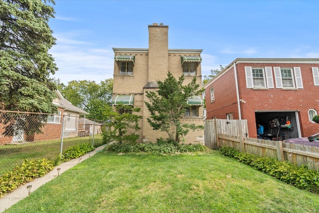 rear view of house featuring a yard