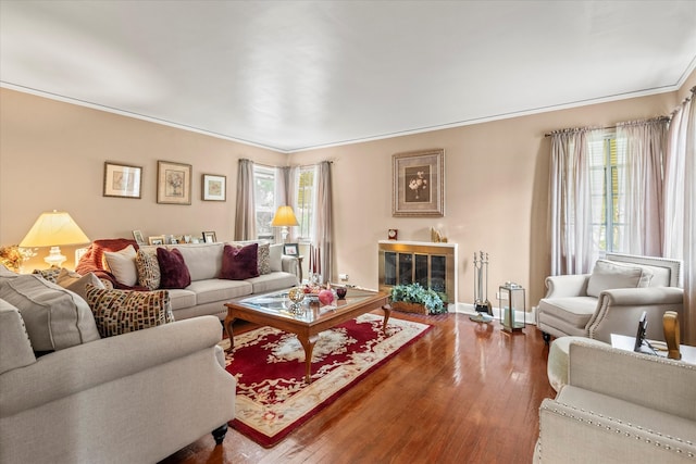 living room featuring wood-type flooring and ornamental molding