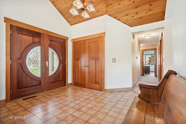 entrance foyer featuring light tile patterned flooring, lofted ceiling, and wood ceiling