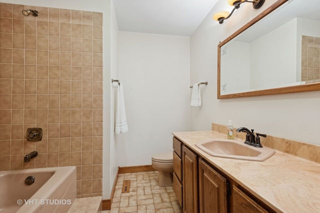 full bathroom featuring toilet, vanity, and tiled shower / bath