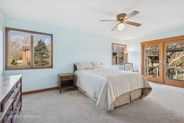 bedroom featuring ceiling fan, light carpet, access to outside, and multiple windows