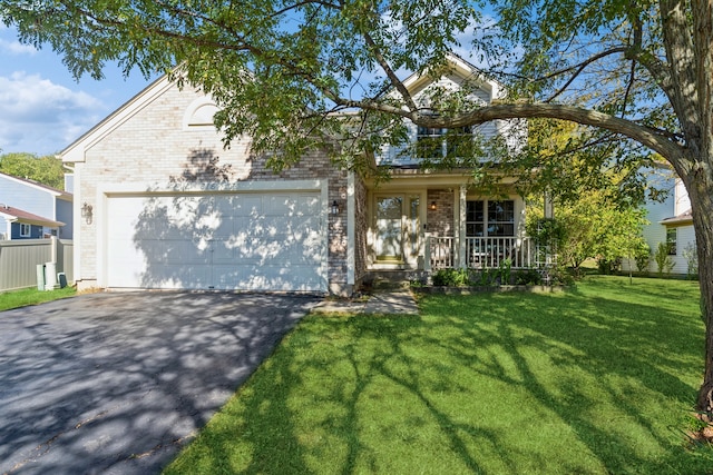 view of front facade with a garage, a porch, and a front yard