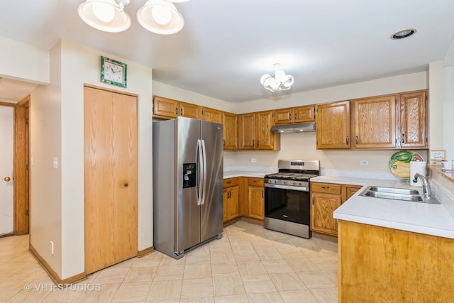 kitchen with stainless steel appliances, an inviting chandelier, and sink