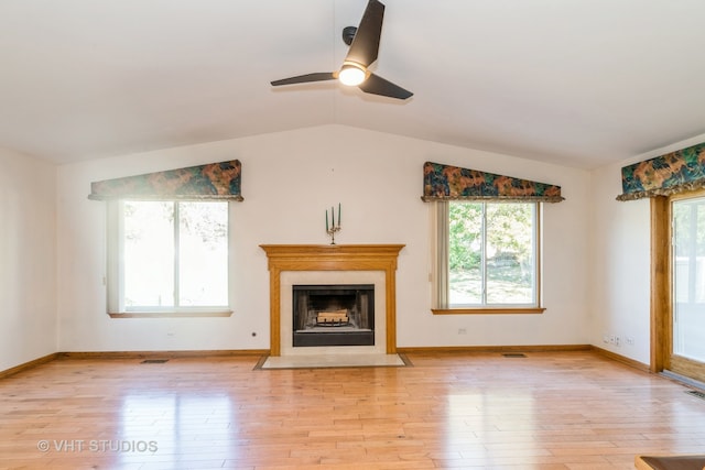 unfurnished living room with ceiling fan, vaulted ceiling, and light hardwood / wood-style floors