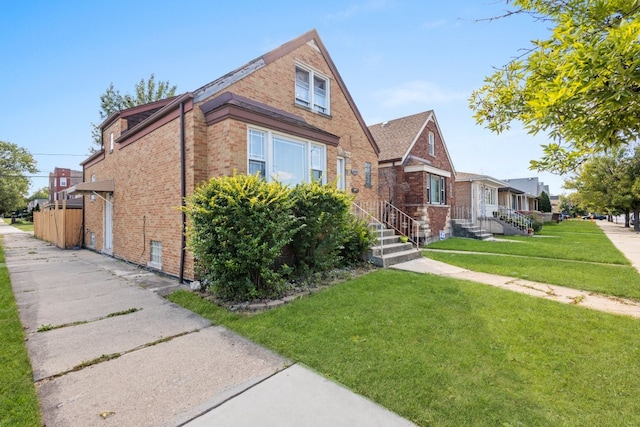 4035 W Marquette Rd, Chicago, IL 60629 - tudor home featuring brick siding and a front yard