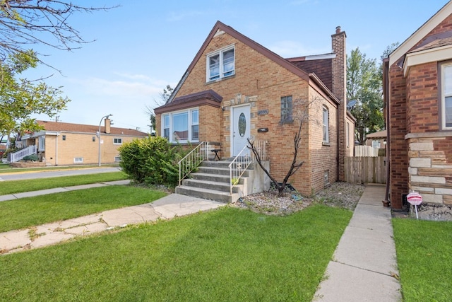 4035 W Marquette Rd, Chicago, IL 60629 - tudor house with a chimney and brick siding