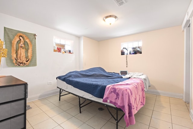 4035 W Marquette Rd, Chicago, IL 60629 - bedroom with multiple windows, light tile patterned floors, and baseboards