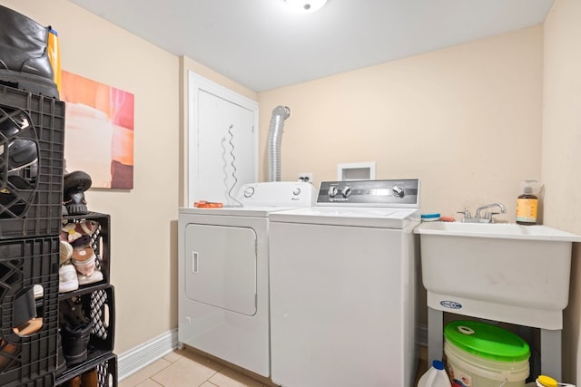 4035 W Marquette Rd, Chicago, IL 60629 - washroom featuring washing machine and clothes dryer, light tile patterned flooring, and baseboards