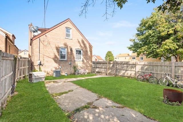 4035 W Marquette Rd, Chicago, IL 60629 - back of house with brick siding, central AC, and a chimney