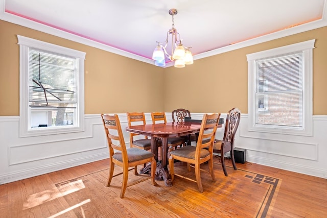4035 W Marquette Rd, Chicago, IL 60629 - dining space featuring wainscoting, a chandelier, ornamental molding, and light wood finished floors