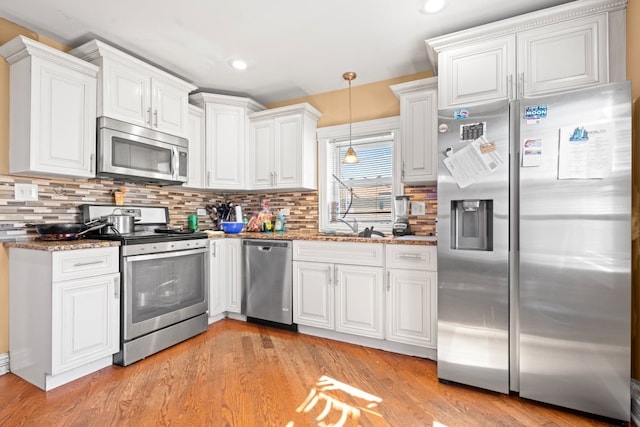 4035 W Marquette Rd, Chicago, IL 60629 - kitchen featuring stainless steel appliances, white cabinets, decorative backsplash, light wood-style floors, and recessed lighting