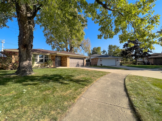 ranch-style house featuring a front yard and a garage