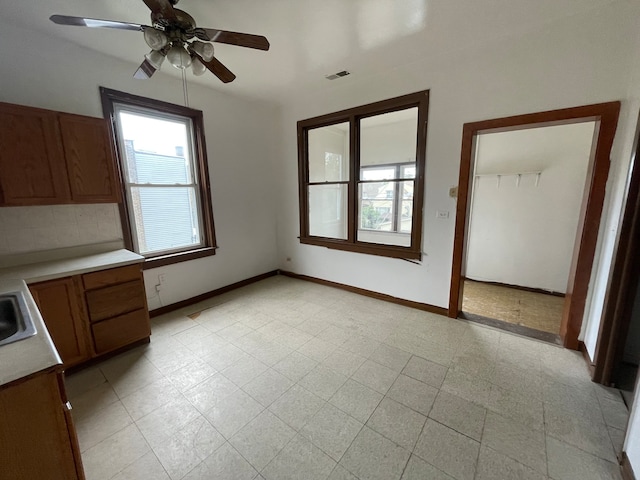 interior space with sink, ceiling fan, and a closet