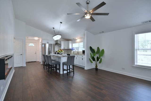 dining room featuring lofted ceiling, dark hardwood / wood-style floors, sink, and ceiling fan