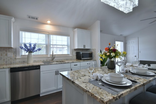 kitchen with white cabinetry, sink, backsplash, and appliances with stainless steel finishes