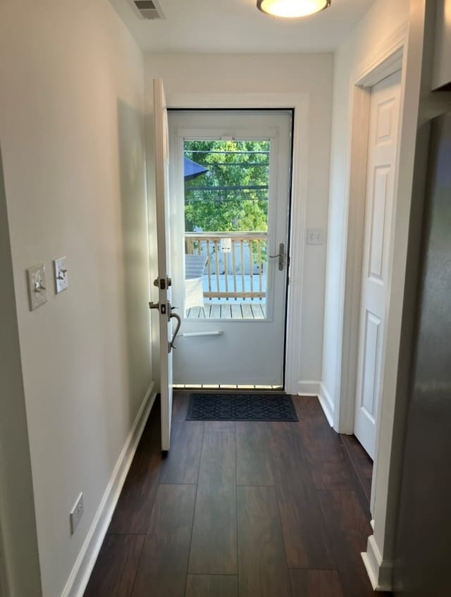 doorway with dark hardwood / wood-style flooring