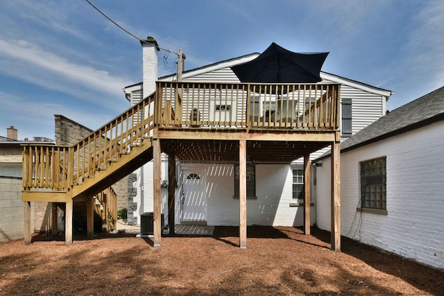 back of house with a wooden deck and central AC