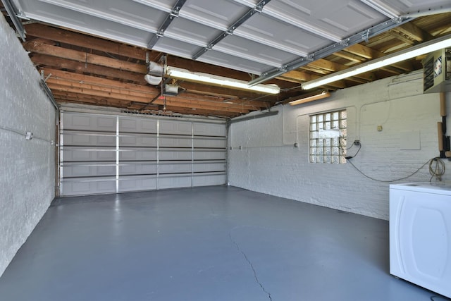 garage featuring a garage door opener and washer / clothes dryer