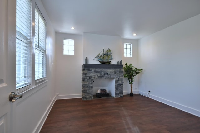 unfurnished living room featuring dark hardwood / wood-style floors and a fireplace