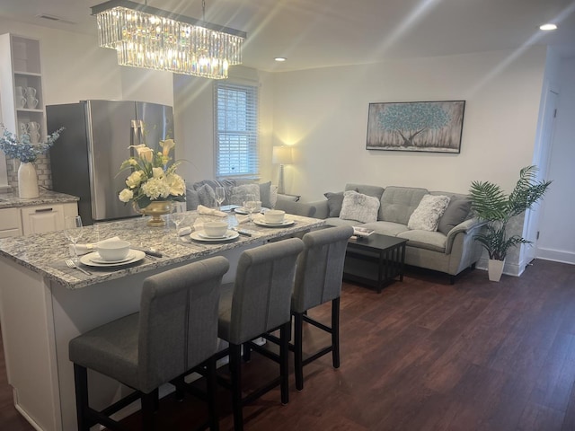 dining area with dark hardwood / wood-style floors