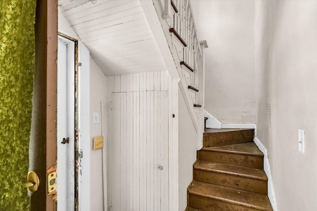 staircase featuring lofted ceiling and wooden ceiling