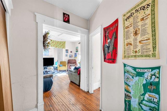 corridor with hardwood / wood-style flooring