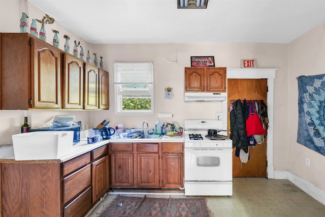 kitchen featuring sink and white gas stove