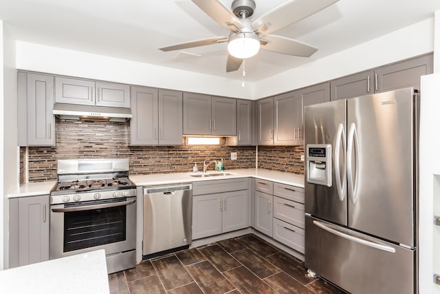 kitchen featuring dark hardwood / wood-style flooring, stainless steel appliances, sink, and gray cabinetry