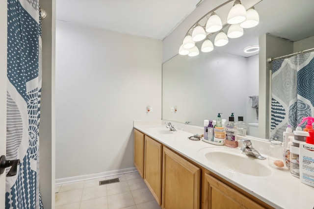 bathroom featuring tile patterned floors, vanity, and toilet