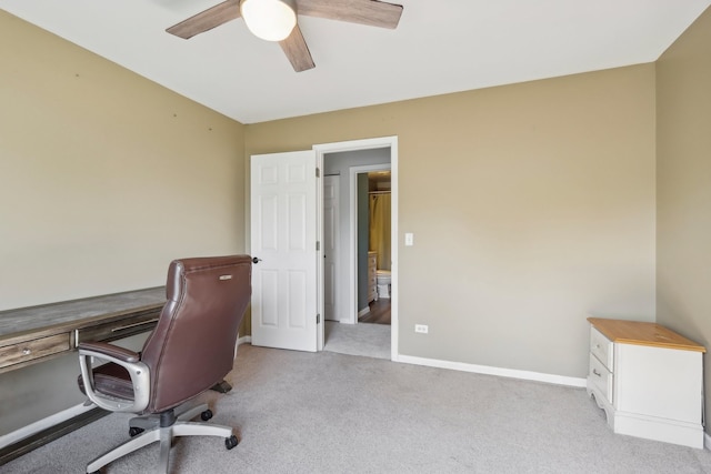 carpeted home office featuring ceiling fan