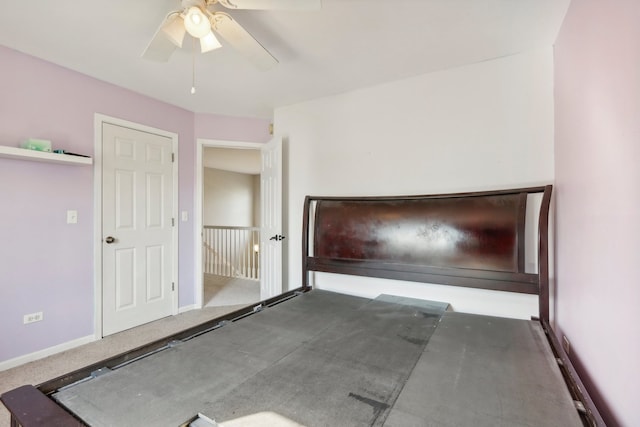 unfurnished bedroom with dark colored carpet and ceiling fan