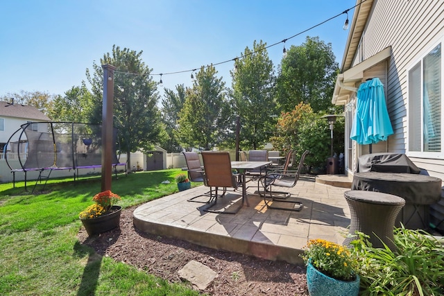 view of patio / terrace with a trampoline and a storage unit