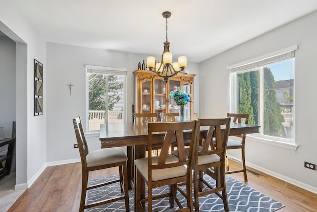 dining space featuring light hardwood / wood-style floors and a healthy amount of sunlight