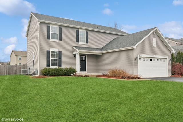 view of front property with central AC unit, a garage, and a front lawn