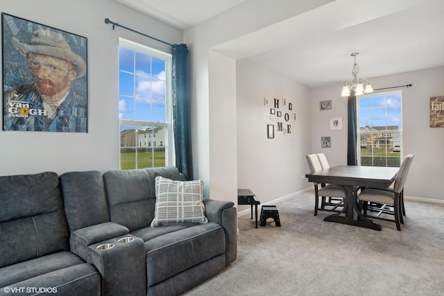 living room featuring carpet and a chandelier