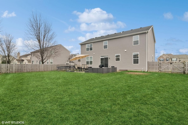 rear view of property featuring outdoor lounge area, a patio area, and a yard